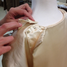 The front bib snaps at the shoulder to the back bodice.