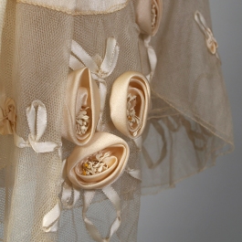 Detail at hem showing ribbonwork on wedding dress, KSUM 1983.1.309.
