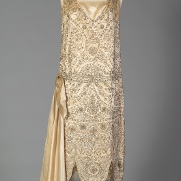 Front view of silk satin wedding dress shown without the train, KSUM 1983.1.334.