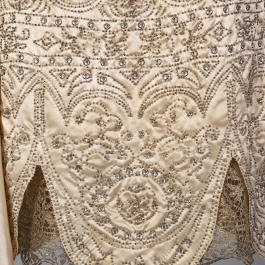 Detail showing hem of silk satin wedding dress, KSUM 1983.1.334.