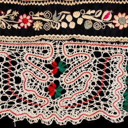 Detail of lace and embroidery on apron hem